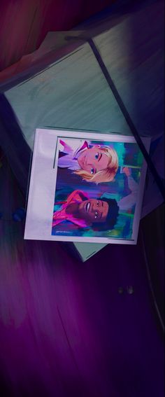 an image of two women in pink and blue on a piece of paper that is hanging from the ceiling