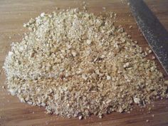 chopped up food sitting on top of a wooden cutting board next to a large knife