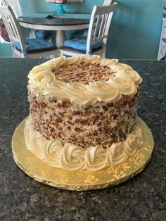 a cake sitting on top of a table covered in frosting and pecanst