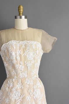 "Outstanding vintage 1950s cocktail party dress by Irene Sargent. This vintage dress features a wonderful Chantilly lace over lace with a gorgeous tier pencil skirt. The bodice is well fitted with bust darts, nipped waist, and a back metal zipper for closure. ✂------ M E A S U R E M E N T S ------- Best Fit: Small Bust: 32.5/33\" Waist: 24.5/25\" Hips: 37.5\" Shoulders: undefined Sleeves: 3.5\" Total Length: 44.5\" Tag/Label: Irene Sargent Material: Chantilly lace, silk Condition: Excellent vint Fitted Tea Length Dress With Scalloped Lace, Fitted Scalloped Lace Tea-length Dresses, Fitted Tea Length Scalloped Lace Dresses, Elegant Cream Vintage Dress For Garden Party, Cream Party Dress With Delicate Lace, 1950s Style Fitted Dresses With Lace Trim, Fitted 1950s Style Dress With Lace Trim, Cream Fitted Dress With Delicate Lace, Elegant Vintage White Dress For Party