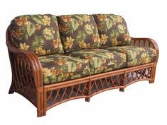 a couch that is made out of wood and has flowers on the backrests