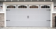 a gray garage door in front of a house