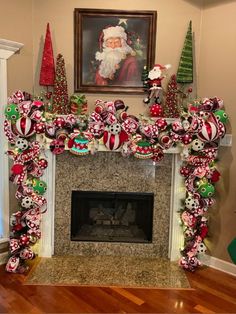 a fireplace decorated for christmas with ornaments around the fire place and santa clause painting on the wall