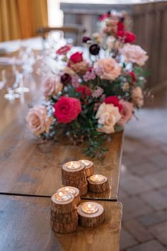 some candles are sitting on a wooden table