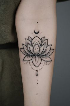 a woman's leg with a black and white lotus tattoo on the left thigh