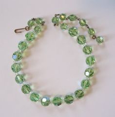 ❘❘❙❙❚❚ ON SALE ❚❚❙❙❘❘ until 12/20/20 at 11:00PM This is a lovely Accessocraft NY spring green crystal set. I think this color might actually be called chrysolite. It is not the usual green you see in crystals or rhinestones, a very sweet spring green color. The necklace was missing a hook, so I replaced it with a vintage hook in brass. The earrings are marked "Accessocraft NY" on the adjustable clip screw tops. The necklace is 13 inches long with an additional 3 1/2 inches of chain for adjustmen Vintage Green Crystal Jewelry, Green Round Crystal Jewelry, Handmade Green Crystal Necklaces, Elegant Green Crystal Necklaces, Elegant Green Crystal Necklace, Green Crystal Jewelry For May Birthstone, Green Crystal Necklaces With Faceted Beads, Elegant Green Crystal Necklaces With Faceted Beads, Elegant Green Faceted Crystal Necklaces