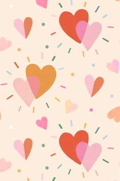 hearts with sprinkles and confetti on a light pink wallpaper