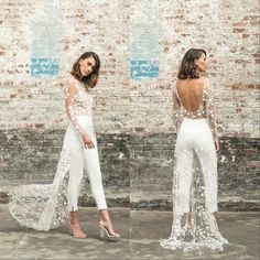 two women standing next to each other in front of a brick wall wearing white outfits