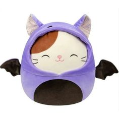 a stuffed animal that is wearing a purple outfit with bat wings on it's head