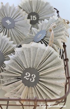 some paper fans with numbers on them in a basket