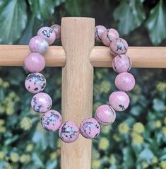 Dear Fellow Light Beings 💜 .  I Am Very Excited To Show You This Beautiful Genuine Rhodonite Crystal Bead Bracelet Handmade using 11.5-12mm High Quality Classic Pink & Black Rhodonite Beads For Reference my Wrist in the Photo is 7 inch so this has been made for 7 - 7.5 inch even 8 inch wrist depending on how you like to wear them Your Bracelet will Come Gift Wrapped Ready for a Perfect Gift!   Rhodonite is a said to be the Stone Of Compassion It is said to be an Emotional Balancer that Clear Aw Light Beings, Rhodonite Crystal, Crystal Bead Bracelet, Pink Rhodonite, Black Gems, Christmas Thank You, Crystal Beads Bracelet, Bracelets Handmade Beaded, Pink Bracelet