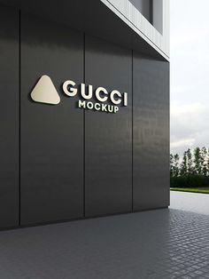 the gucci mockup sign is on the side of a building