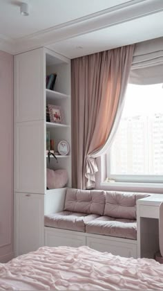 a bedroom with a bed, desk and bookcase in front of a large window