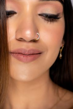 a close up of a woman with her nose piercings in the shape of a ring