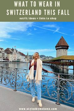 a woman standing in front of the water with text overlay that reads what to wear in switzerland this fall