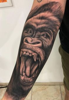 a man's arm with an animal tattoo on it, and the image of a gorilla