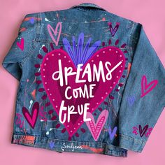 a jean jacket with the words dreams come true written on it