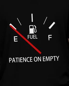 a man wearing a black t - shirt that says fuel efficiency on empty