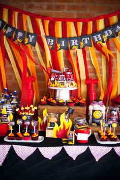 a birthday party with firetruck decorations and desserts