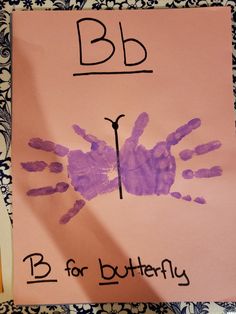 a child's handprint on a piece of paper with the letter b for butterfly