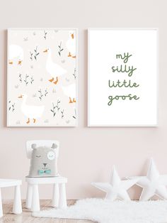 two posters on the wall in a child's room with white furniture and toys