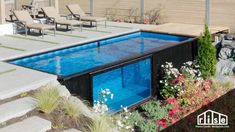 an empty swimming pool in the middle of a garden with flowers and plants around it