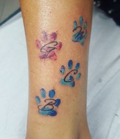 a person with a tattoo on their foot that has dogs paw prints all over it