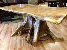 a large wooden table sitting on top of a hard wood floor