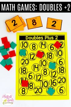 a math game with pieces of colored paper next to it and numbers on the board