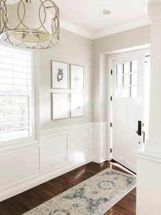 a hallway with white walls and wood floors