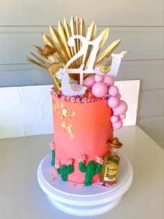 a birthday cake decorated with pink and gold decorations