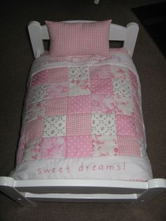 a pink and white toddler bed with the words sweet dreams written on it