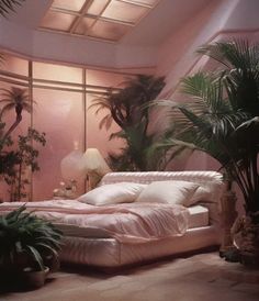 a bed sitting in the middle of a bedroom next to potted plants