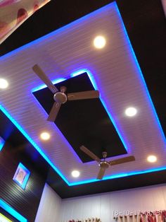 the ceiling fan is lit up with blue lights