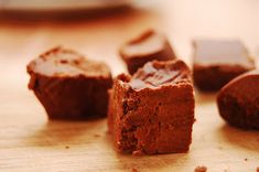 several pieces of brownie sitting on top of a wooden table