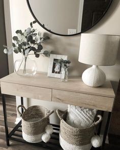 a table with two baskets and a mirror