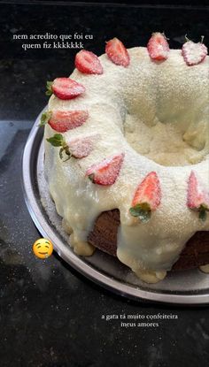 a cake with white frosting and strawberries on top