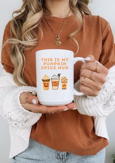 a woman is holding a coffee mug that says, this is my pumpkin spice hug