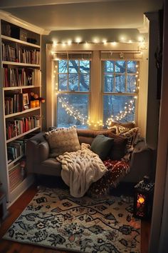 a living room filled with lots of furniture and bookshelves covered in christmas lights