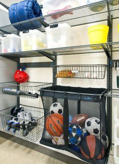 there are many sports items on the shelves in this garage storage area, including basketballs, soccer balls, and baseball mitts