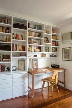 a room with bookshelves and a desk in it