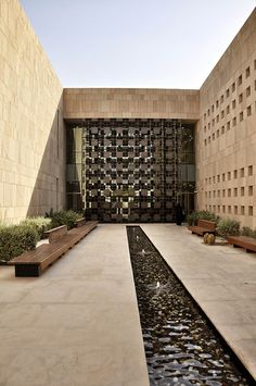 an empty courtyard with benches and water feature