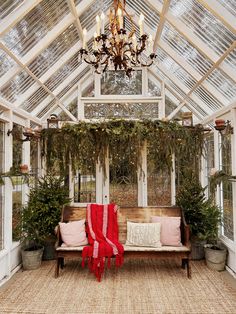 the inside of a greenhouse with lots of plants and lights hanging from it's ceiling