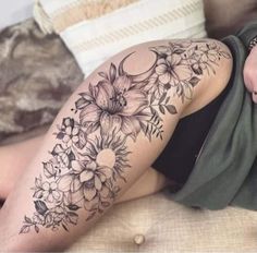 a woman laying on top of a bed covered in tattoos