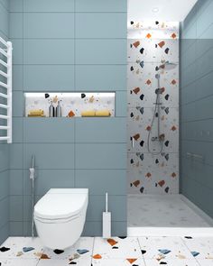 a white toilet sitting in a bathroom next to a walk in shower and tiled walls