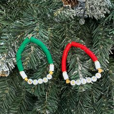 two christmas bracelets are hanging on a tree