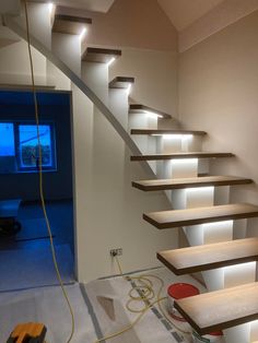 the stairs are lit up and ready to be installed into the house's living room