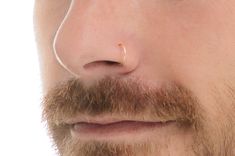 a man with a nose ring on his nose