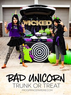 two girls standing in front of a trunk with halloween decorations on it and the words, w