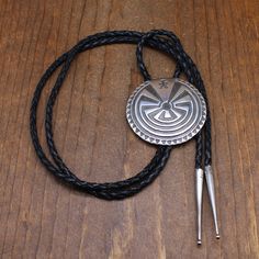 Sterling silver cast Man in the Maze bolo tie. This bolo is 2 5/16" diameter. The back is stamped STERLING R. The cord is 45" long including the 2 1/8" long sterling silver tips. The Man in the Maze design is used by several Native American tribes. The Tohono O'Odham claim it as their tribal symbol. It has to do with working through life's trials before going to a final resting place. This bolo is in good condition. Thank you for shopping in our store. Please let us know if you have questions. B Silver Western Jewelry With Adjustable Cord, Silver Lariat Bolo Tie With Adjustable Length, Western Style Silver Jewelry With Adjustable Cord, Silver Lariat Bolo Ties With Adjustable Length, Classic Adjustable Lariat Bolo Tie, Artisan Silver Lariat Bolo Tie, Southwestern Silver Jewelry With Adjustable Cord, Silver Bolo Tie With Sliding Knot As Gift, Western Silver Bolo Tie With Adjustable Cord